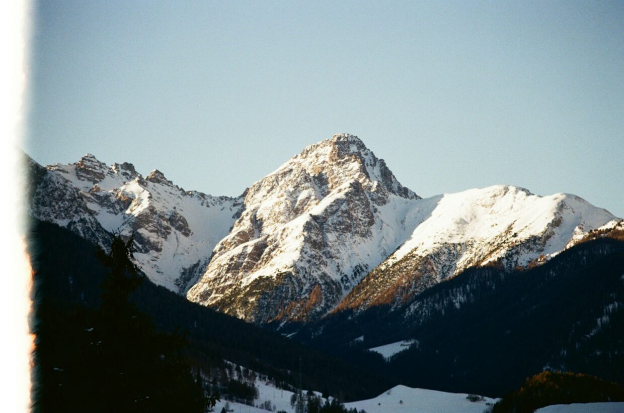 A snow covered mountain range with a clear blue sky